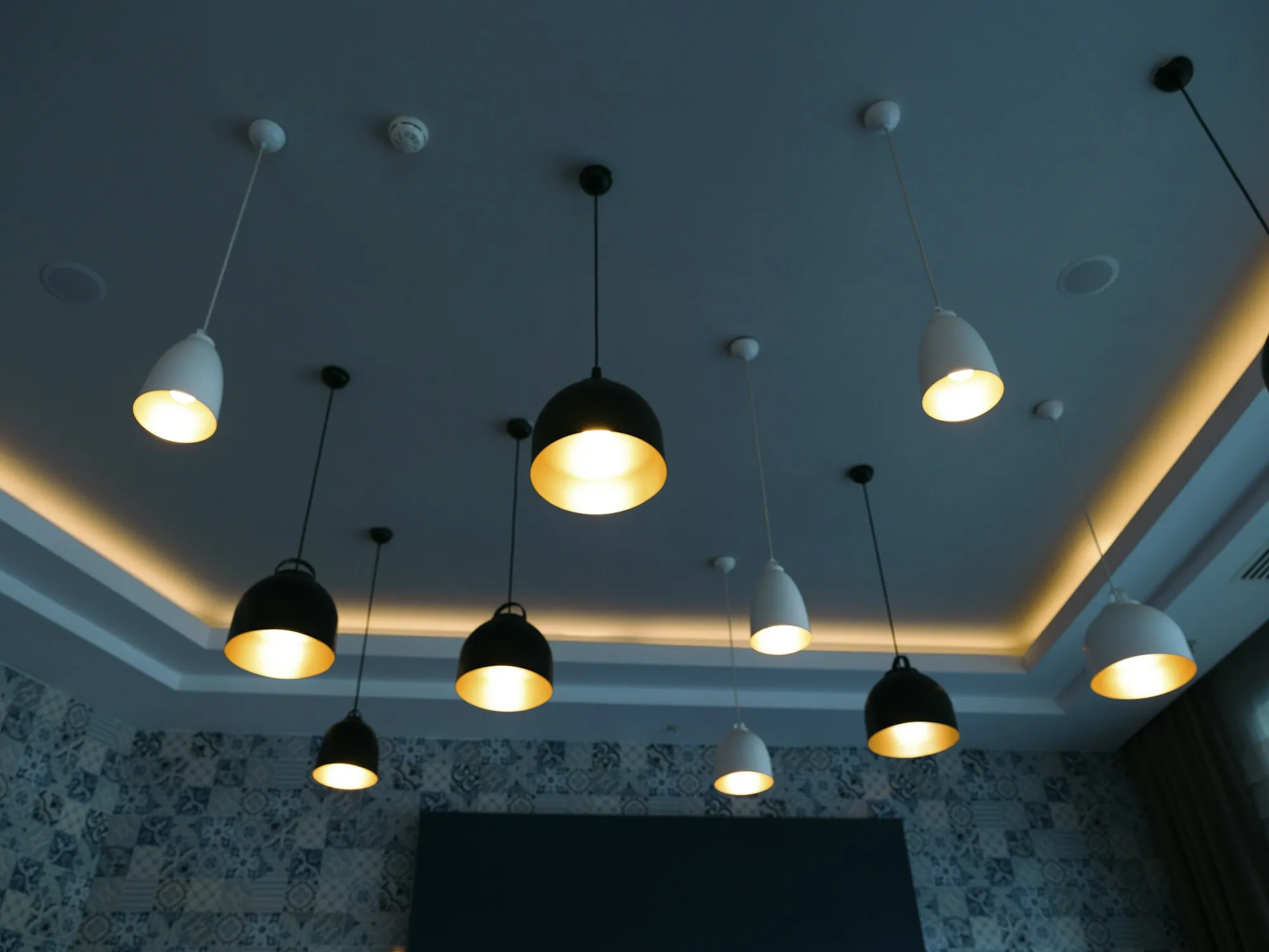 A cluster of pendant lights above a dining area