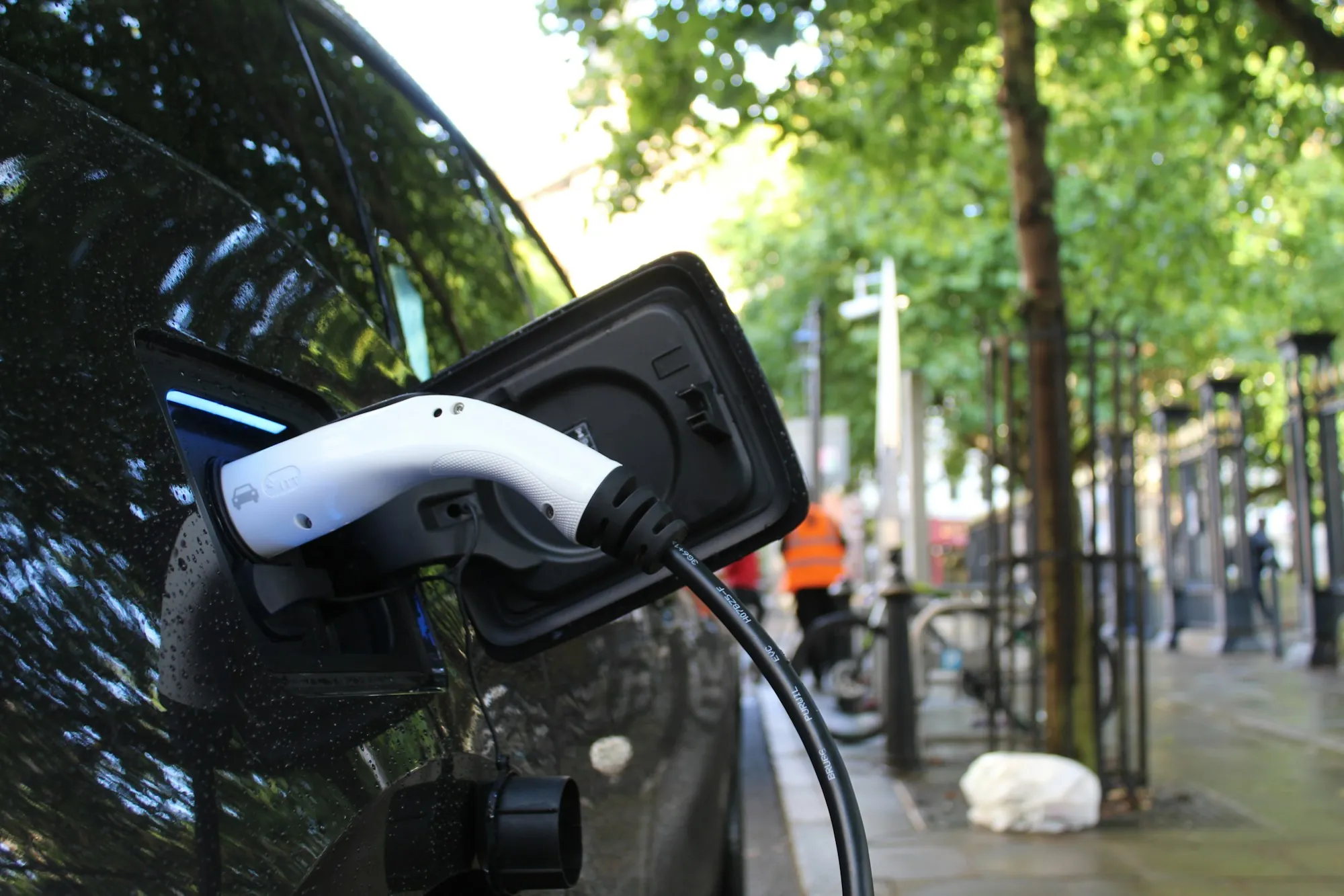 A charging cable plugged into an electric car